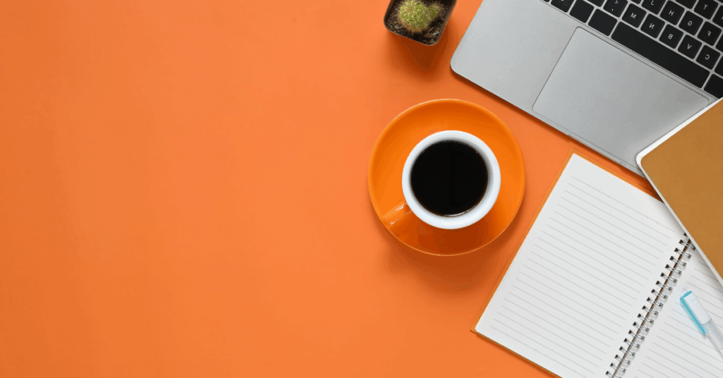 Business owner reviewing organized finances at a clean workspace, symbolizing the 3-step financial planning process for business owners – awareness, alignment, and action.