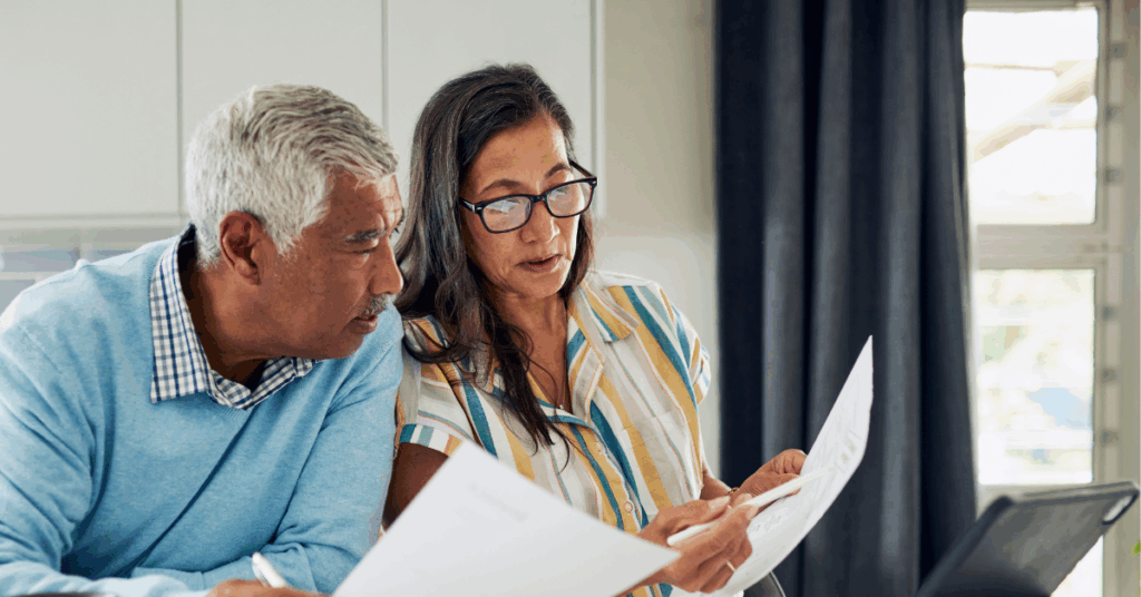 Married couple reviewing IRA statements while planning charitable giving in retirement