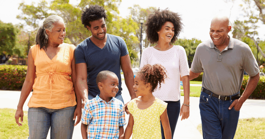 Multi-generation family walking together outdoors, representing values-based conversations about charitable giving and family legacy