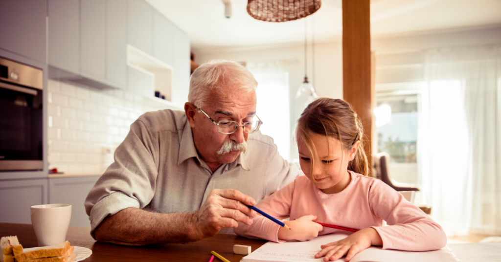 Grandfather doing homework with his granddaughter.
